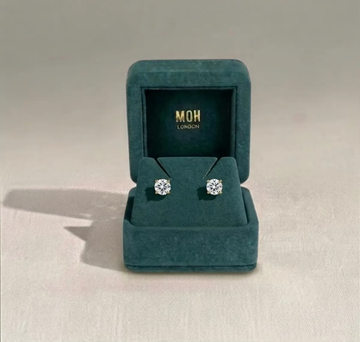 Diamond stud earrings in MOH London teal jewellery box