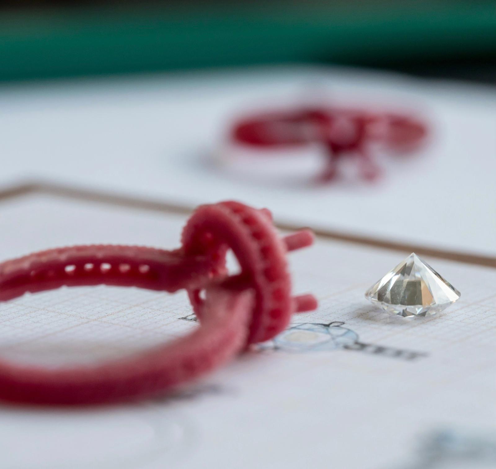 Wax ring prototype with a loose diamond on a jeweller’s workbench during bespoke design