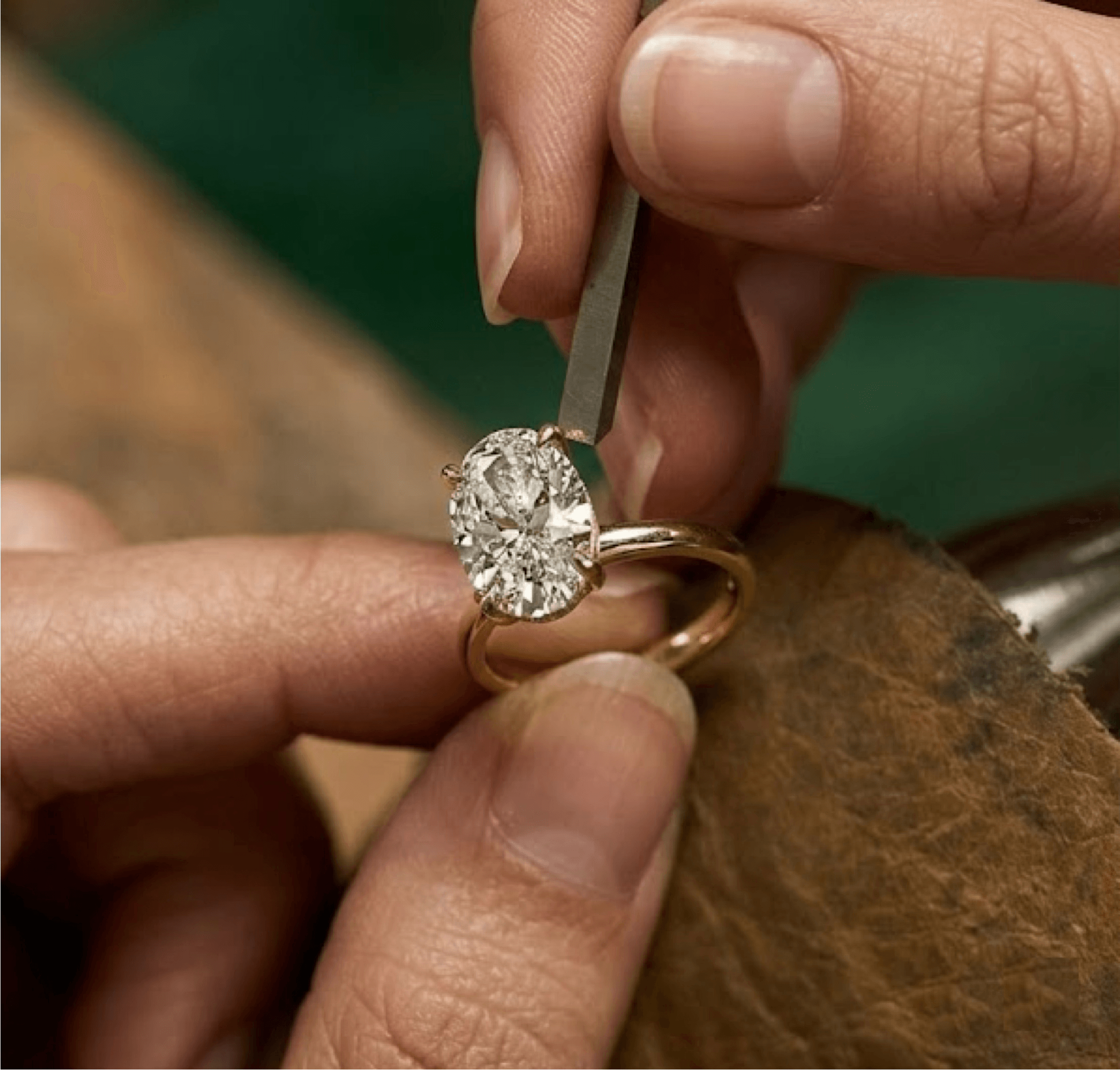 Master jeweller hand-setting an oval diamond at the MOH workshop