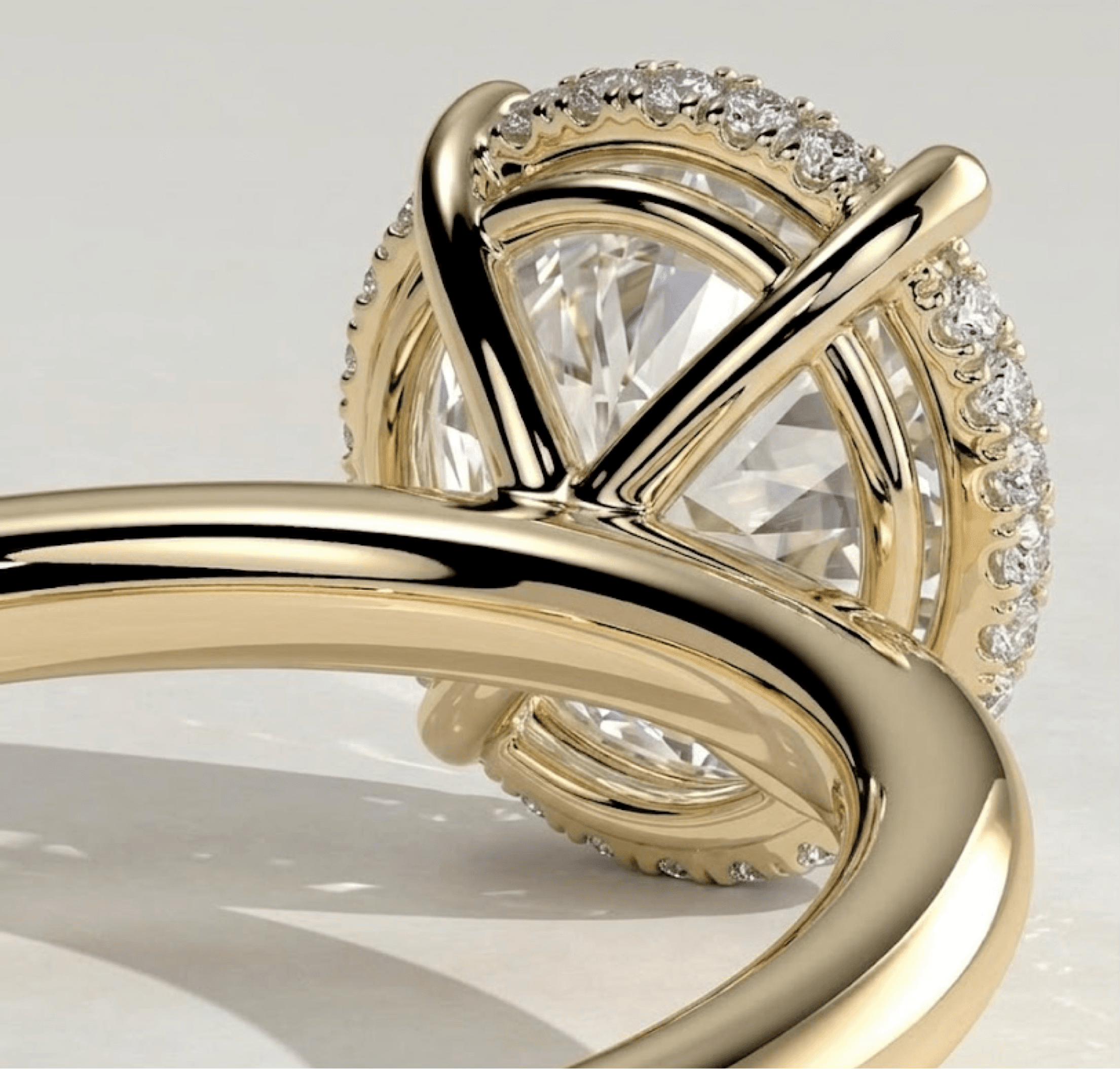 Close-up of a hidden halo diamond ring setting in yellow gold