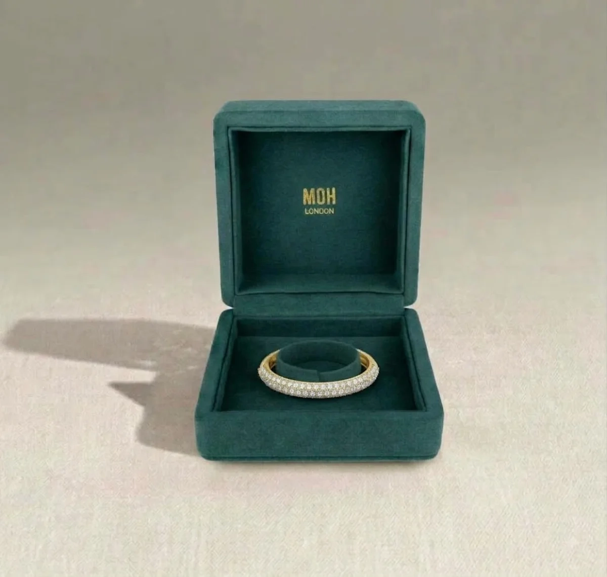 Diamond bangle presented in MOH London teal jewellery box