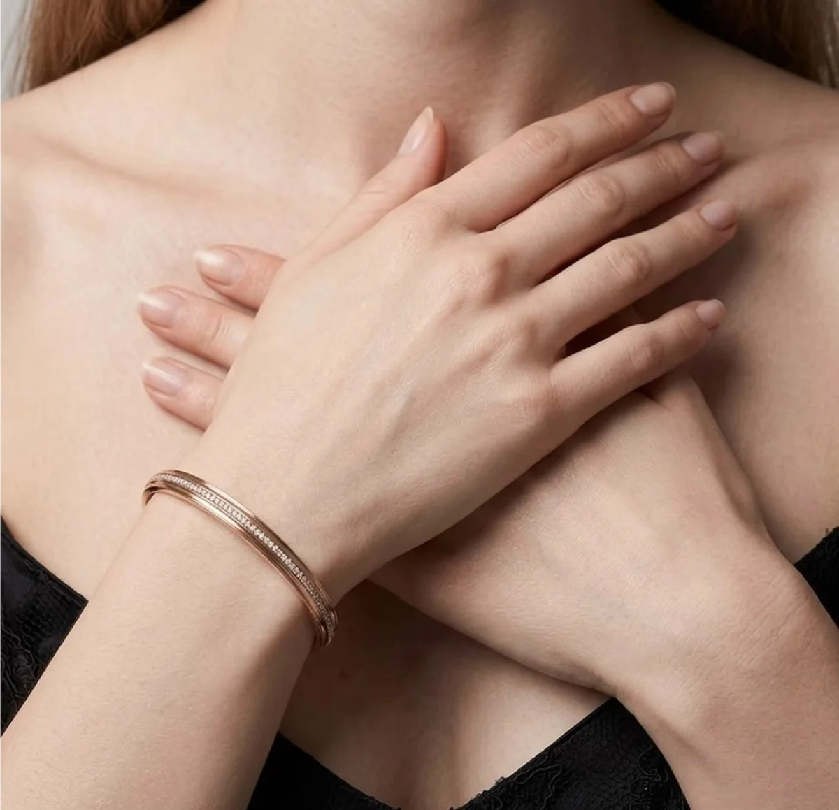 Diamond bangle on crossed wrists — lifestyle shot