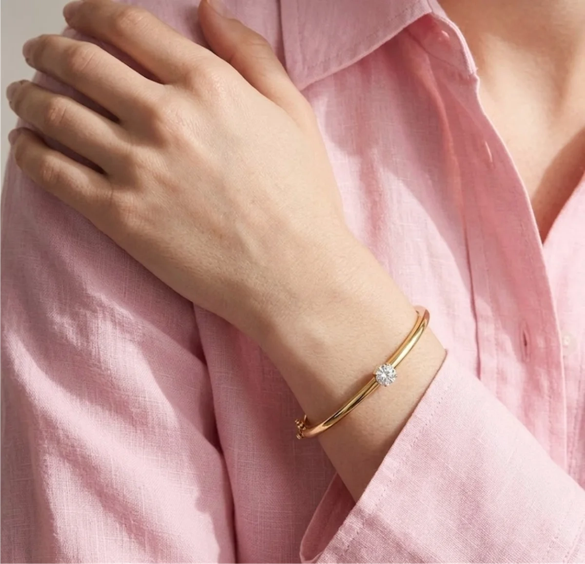 Diamond bangle worn on wrist — editorial styling