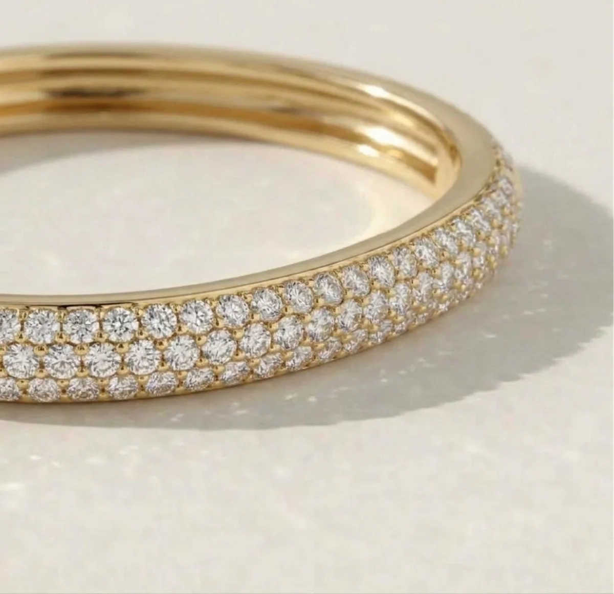 Pavé diamond bangle in yellow gold — close-up detail