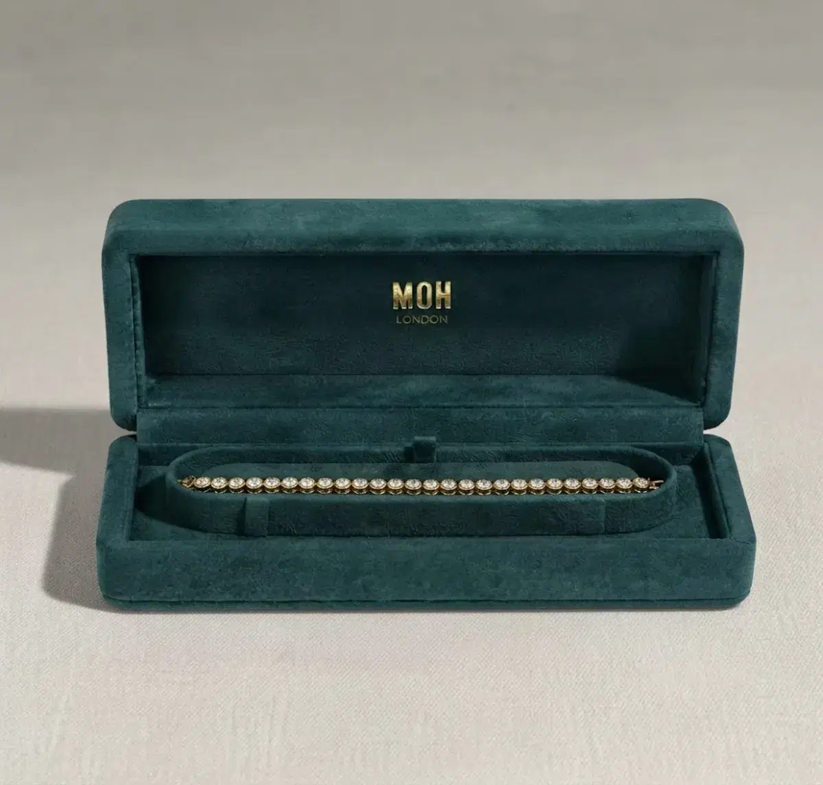 Diamond tennis bracelet in MOH London teal presentation box