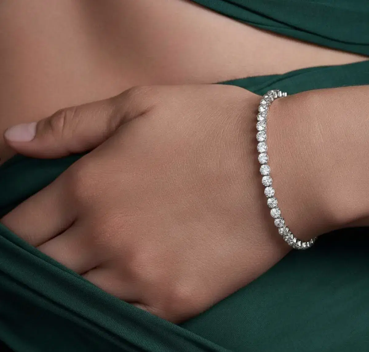 Prong-set diamond tennis bracelet worn on wrist