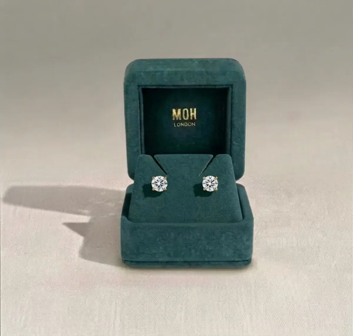 Diamond stud earrings in MOH London teal jewellery box