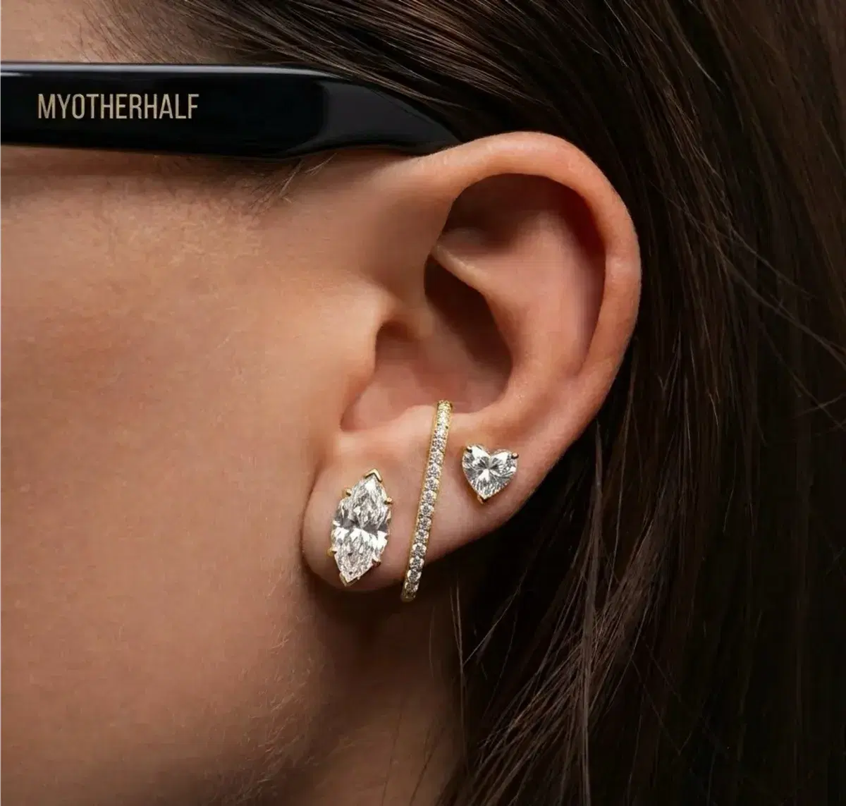Diamond earrings styled on ear with multiple piercings