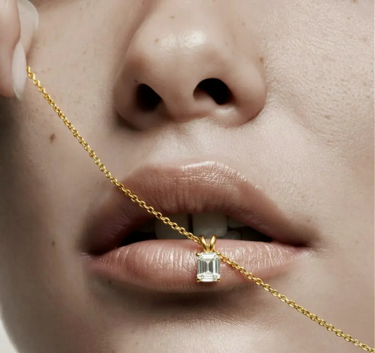Emerald-cut diamond pendant on chain — editorial close-up