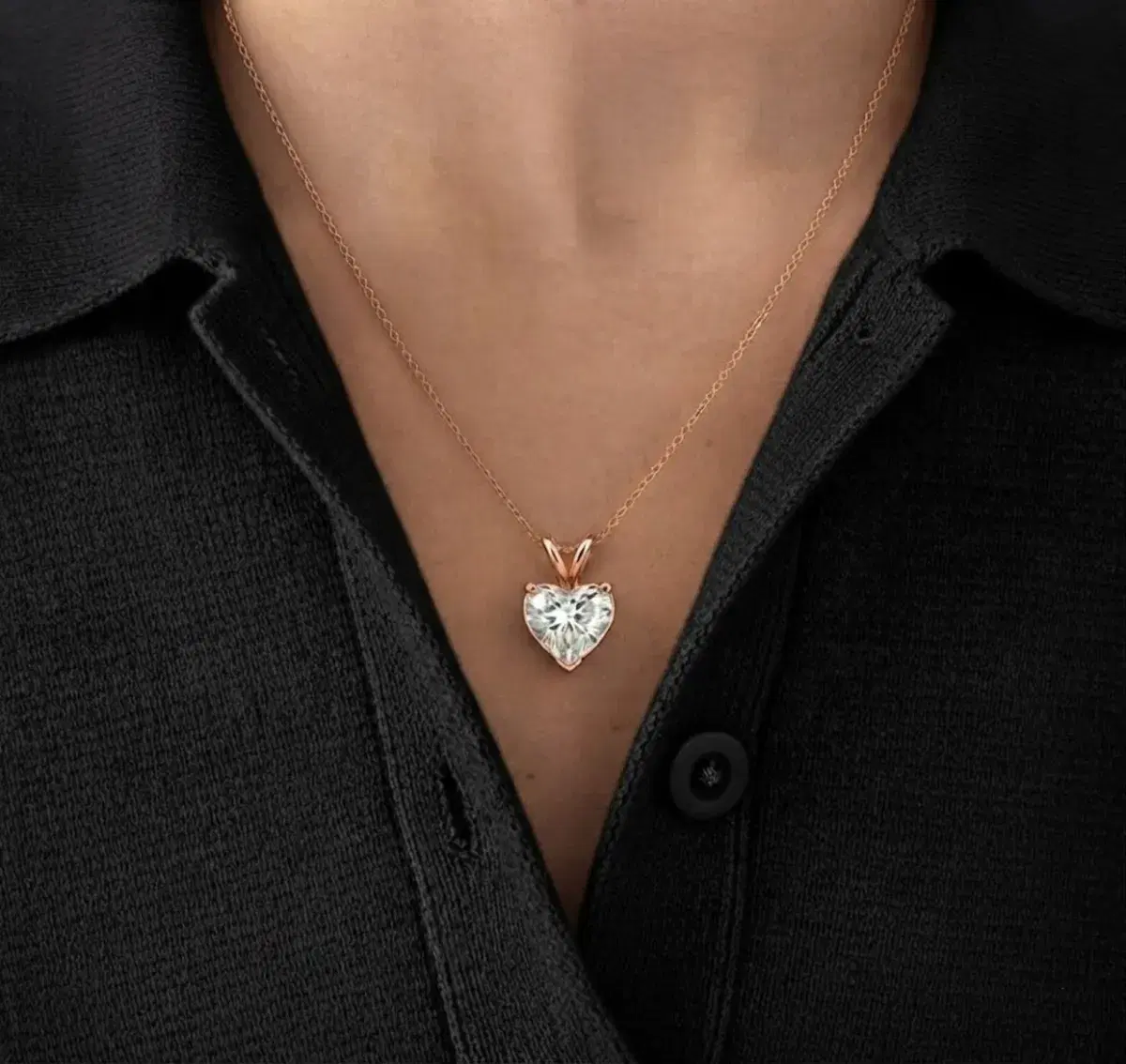 Heart-shaped diamond pendant worn on neckline