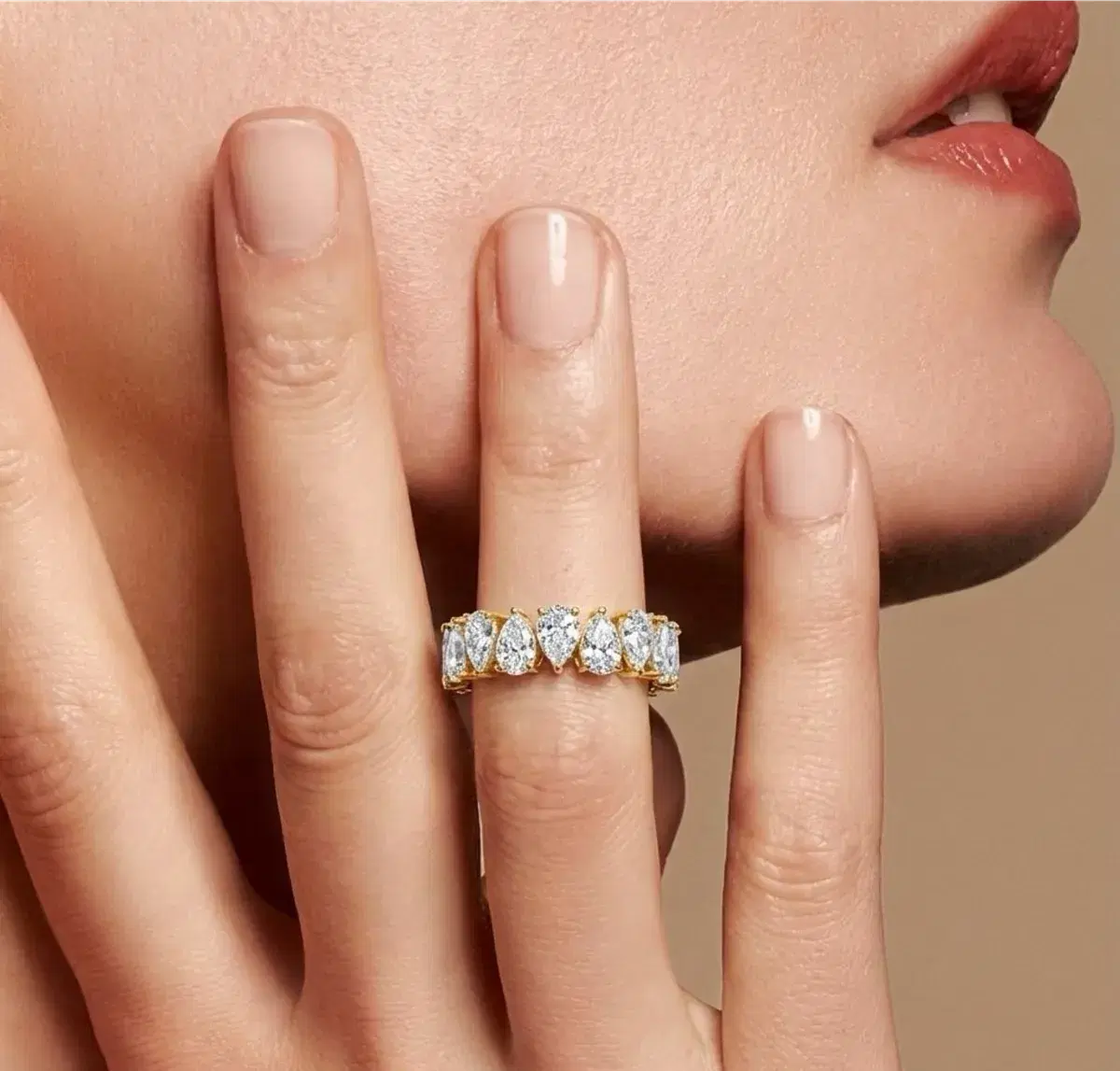 Pear diamond eternity ring worn on hand