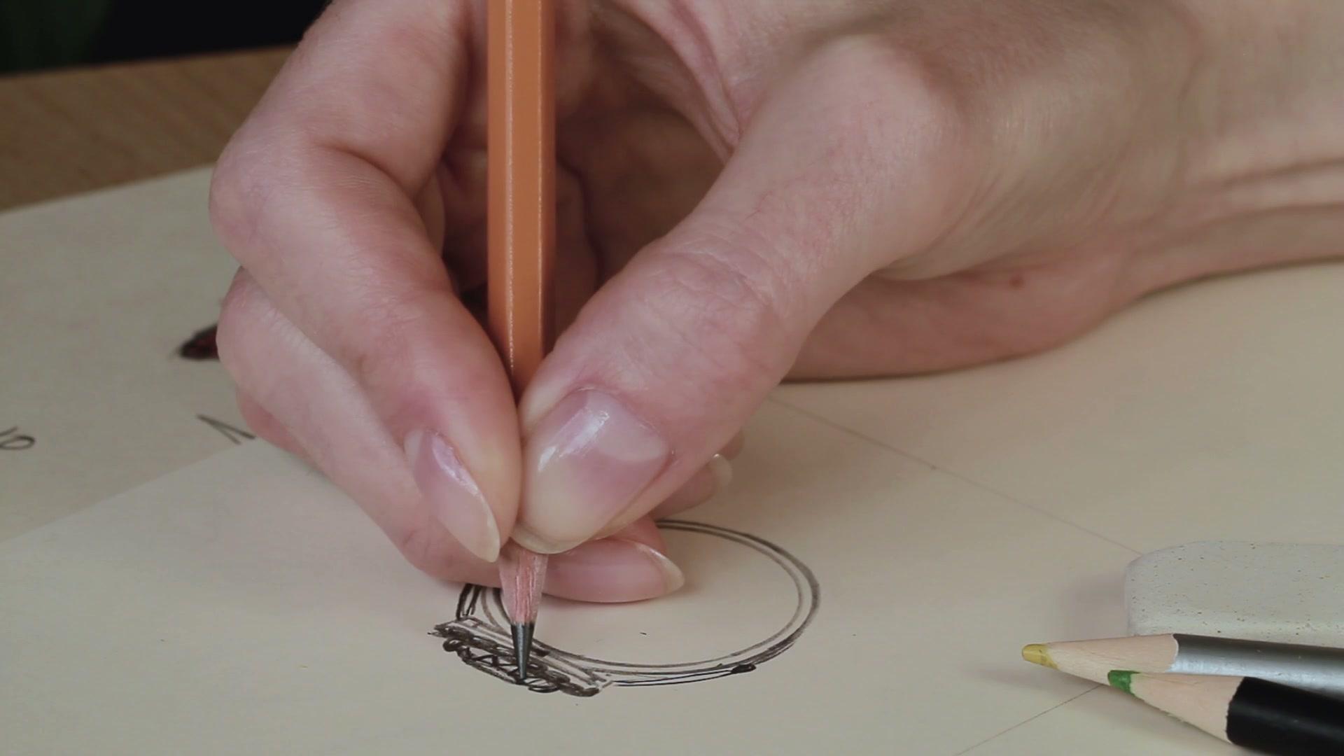 Jewellery designer hand-sketching a ring design