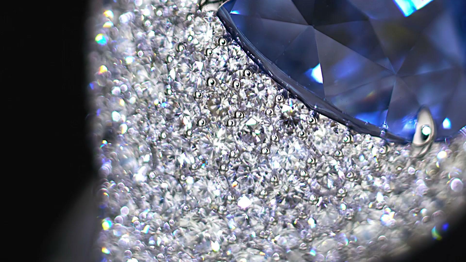 Diamond engagement ring spinning on black background